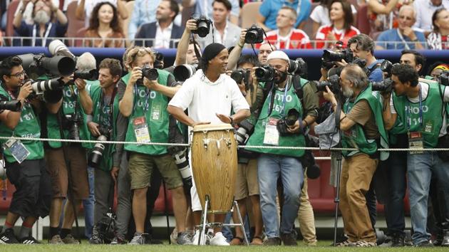 Former Brazilian football player Ronaldinho, surrounded by photographers, played drums as he took part in the closing ceremony of the FIFA World Cup at the Luzhniki Stadium in Moscow on Sunday.(AP)