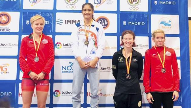 Gold medallist Vinesh Phogat of India poses for pictures during the medal ceremony of women’s freestyle 50 kg wrestling at the Spanish Grand Prix on Sunday.(PTI)
