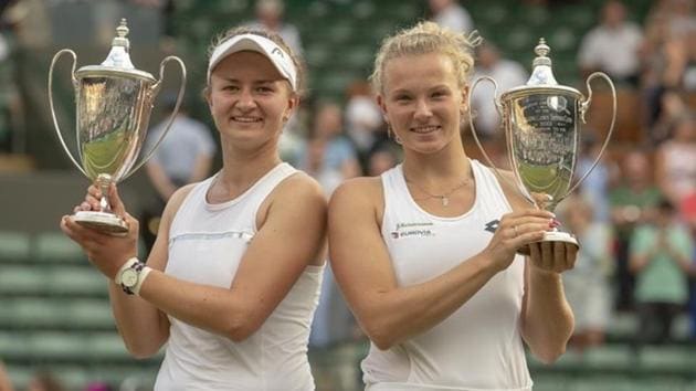Barbora Krejcikova (CZE) and Katerina Siniakova (CZE) pose with their trophies after winning Wimbledon women’s doubles final on at All England Lawn and Croquet Club.(USA TODAY Sports)