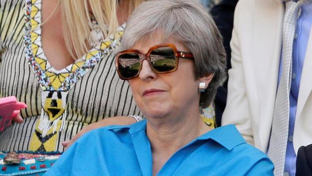 Britain's Prime Minister Theresa May sits in the Royal Box ahead of Serbia's Novak Djokovic men's singles final against South Africa's Kevin Anderson.(REUTERS Photo)