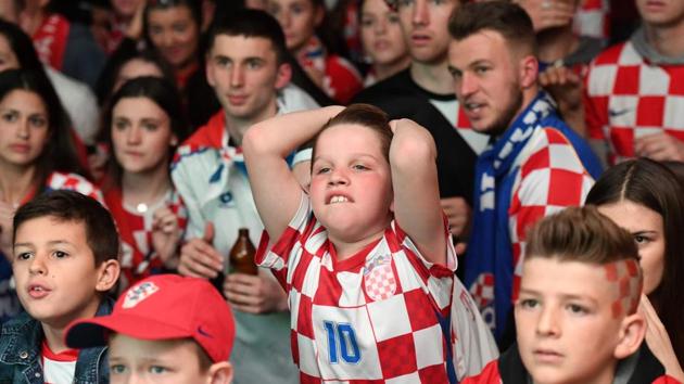 Croatian fans watching on giant screens, react as France scores a goal while they watch the World Cup final match between France vs Croatia in Melbourne. (AFP) 