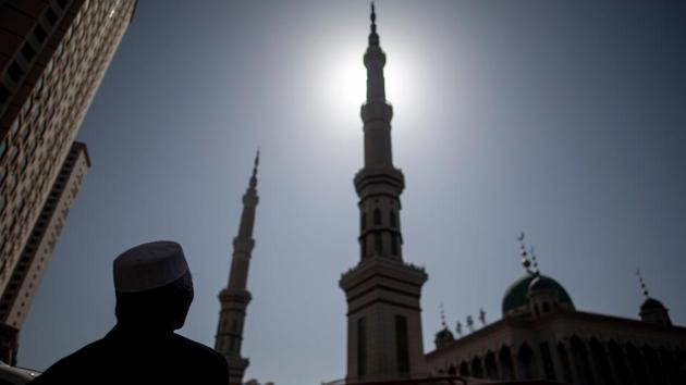 An ethnic Hui Muslim man stands in front of Laohuasi Mosque after Friday prayers in Linxia, Gansu province. Green-domed mosques still dominate the skyline of China’s “Little Mecca”, but they have undergone a profound change -- no longer do boys flit through their stone courtyards en route to classes and prayers. (Johannes Eisele / AFP) An ethnic Hui Muslim man stands in front of Laohuasi Mosque after Friday prayers in Linxia, Gansu province. Green-domed mosques still dominate the skyline of China’s “Little Mecca”, but they have undergone a profound change -- no longer do boys flit through their stone courtyards en route to classes and prayers. (Johannes Eisele / AFP)