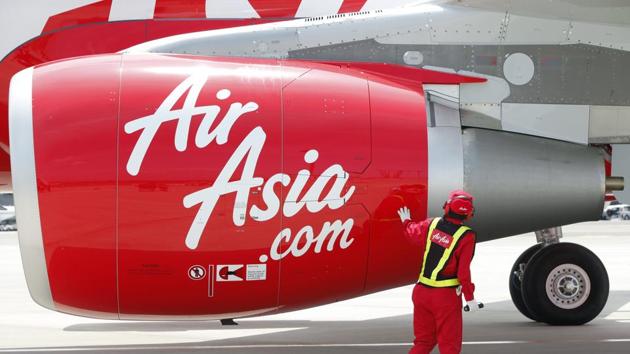 An AirAsia Japan Co engineer looks at an engine of the company's first Airbus SAS A320 aircraft.(Kiyoshi Ota/Bloomberg)