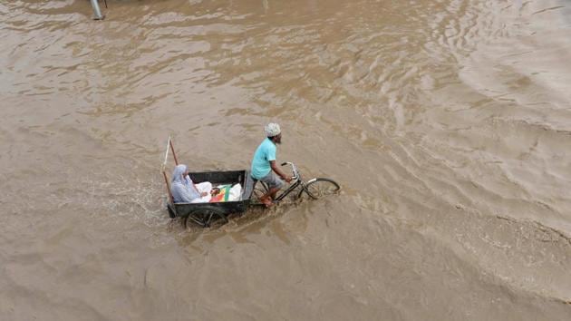 A rickshaw-puller carries an elderly woman through a flooded street after rains in Patiala, Punjab. Also, rail and road traffic were hit in various parts of Kerala due to waterlogging as heavy rains continued to pound the state with the South West Monsoon becoming active again. (PTI) A rickshaw-puller carries an elderly woman through a flooded street after rains in Patiala, Punjab. Also, rail and road traffic were hit in various parts of Kerala due to waterlogging as heavy rains continued to pound the state with the South West Monsoon becoming active again. (PTI)