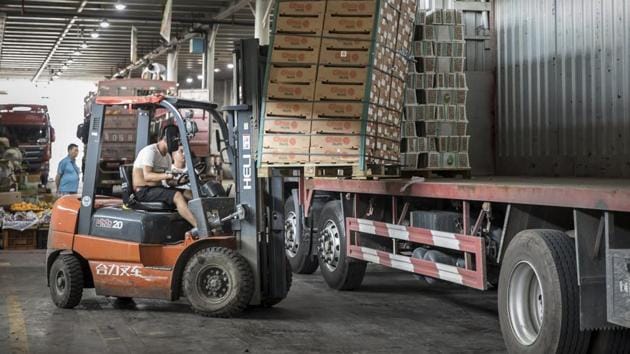 A man uses a forklift to unload a pallet of imported fruit from a truck at a wholesale market in Shanghai. China released its gross domestic product figures on July 16.(Bloomberg) A man uses a forklift to unload a pallet of imported fruit from a truck at a wholesale market in Shanghai. China released its gross domestic product figures on July 16.(Bloomberg)