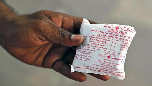 A man shows a packet of government-supplied 'Nirodh' condoms after collecting it from a distribution centre at a hospital in New Delhi.(Reuters)
