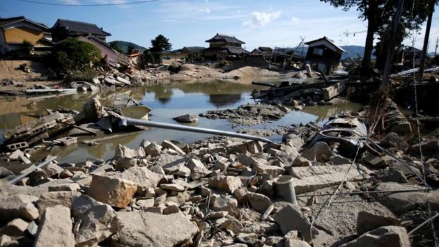 Submerged and destroyed houses seen near the site where embankments broke along Suemasa River in Mabi town. Resident Akutagawa said if the work had only begun a couple of years, disaster might have been averted. But Hiroshi Kono, an emergency management officer at Kurashiki City said approval rests only on the land ministry’s decision after reviewing requests from across Japan. (Issei Kato / REUTERS) 