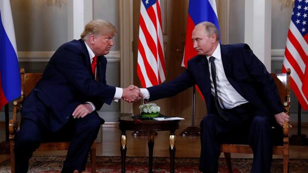 US President Donald Trump and Russia's President Vladimir Putin shake hands as they meet in Helsinki, Finland on July 16. (REUTERS) US President Donald Trump and Russia's President Vladimir Putin shake hands as they meet in Helsinki, Finland on July 16. (REUTERS)