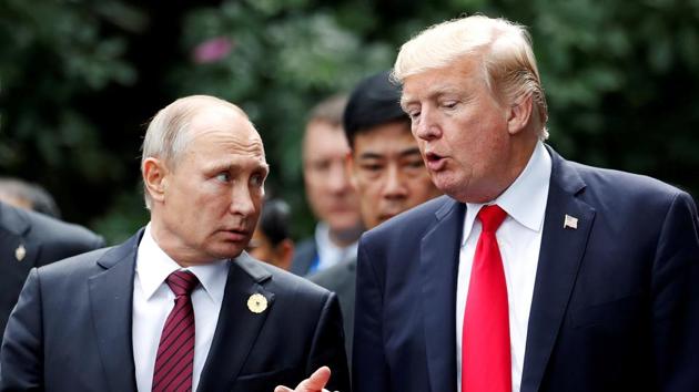 US President Donald Trump and Russia's President Vladimir Putin talk during the family photo session at the APEC Summit in Danang, Vietnam, in November 2017.(Reuters File Photo)