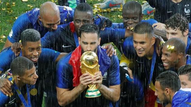 Soccer Football - World Cup - Final - France v Croatia - Luzhniki Stadium, Moscow, Russia - July 15, 2018 France's Adil Rami kisses the trophy as he celebrates with team mates after winning the World Cup.(Reuters)