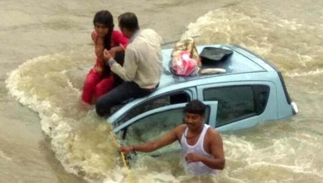 Villagers help the passengers reach the river bank at Taloja.(HT Photo)