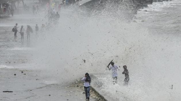People enjoy the high tide at Marine Drive in Mumbai, India, on Sunday, July 15, 2018. (Kunal Patil/HT Photo) People enjoy the high tide at Marine Drive in Mumbai, India, on Sunday, July 15, 2018. (Kunal Patil/HT Photo)