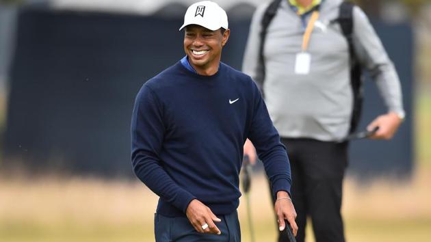 US golfer Tiger Woods smiles as he putts on the 9th green during a practice round at The 147th Open golf Championship at Carnoustie, Scotland.(AFP)