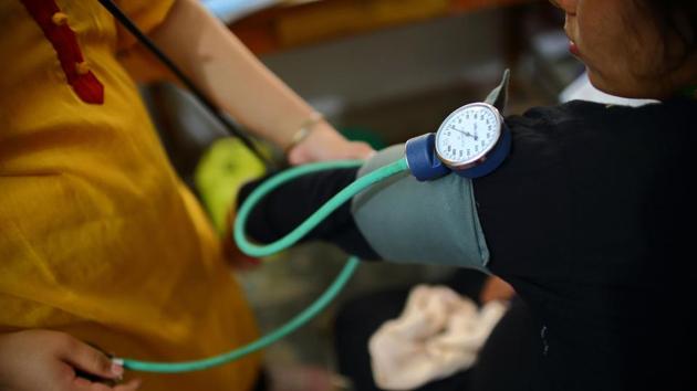 A health worker checks the blood pressure of a pregnant woman at a health centre. Suresh Tiwari, one of the original architects of the scheme said that one of the main reasons rural women did not go to a hospital during childbirth was because they lacked cash to pay for transportation. The programme started in 2005 with British aid money, but has since been taken over by the Nepal government. (Bikram Rai / AFP) A health worker checks the blood pressure of a pregnant woman at a health centre. Suresh Tiwari, one of the original architects of the scheme said that one of the main reasons rural women did not go to a hospital during childbirth was because they lacked cash to pay for transportation. The programme started in 2005 with British aid money, but has since been taken over by the Nepal government. (Bikram Rai / AFP)
