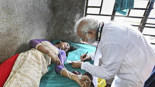 Prime Minister Narendra Modi visits a woman, who was injured after a portion of a tent collapsed at his rally, at a hospital in Midnapore on July 16. (PTI Photo) Prime Minister Narendra Modi visits a woman, who was injured after a portion of a tent collapsed at his rally, at a hospital in Midnapore on July 16. (PTI Photo)