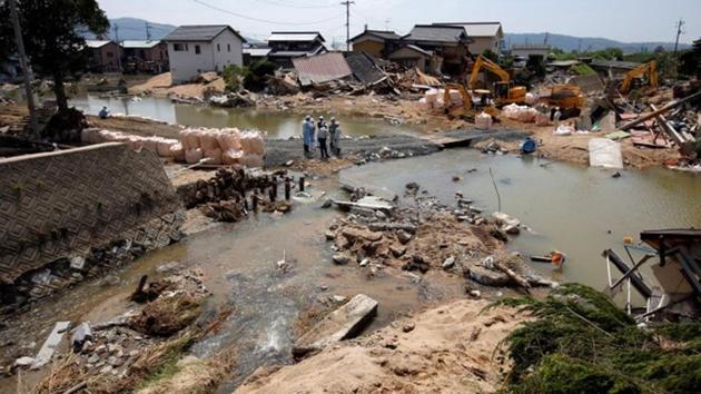 During floods, a man in his 90s was unable to leave his house was later found dead. Now there are families who no longer want to stay in the town. “Something similar might happen again in a few years,” said Yamashita as workers slowly cleared a mound of rubble in front of his home. “My wife says she doesn’t want to live here anymore.” (Issei Kato / REUTERS) 