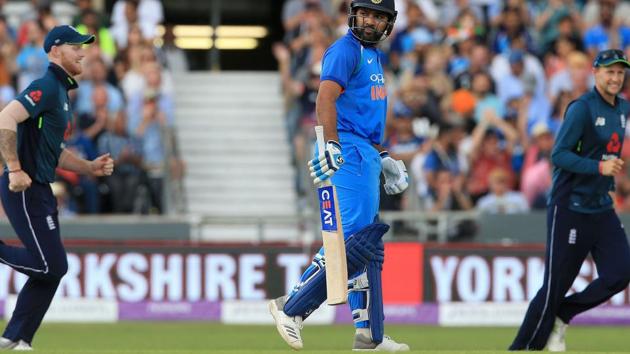 India's Rohit Sharma (C) walks back to the pavilion after losing his wicket for two runs during the third One Day International (ODI) cricket match between England and India. (AFP)