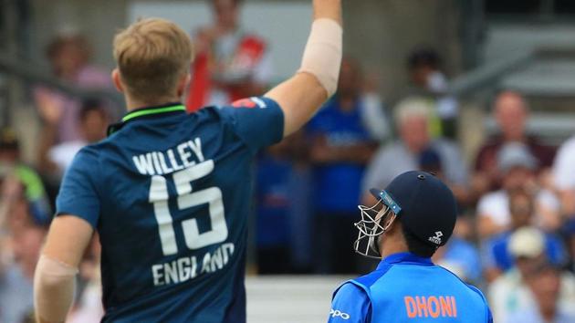 England's David Willey celebrates after England's Jos Buttler took the wicket of India's MS Dhoni. (AFP)