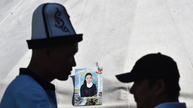 A photo frame of Burulai Turdaaly Kyzy, a 20-year-old medical student seen outside a tent during a traditional ceremony to mark 40 days since she was murdered in a police station by her kidnapper, at a nomadic yurt pitched next to her family home in the settlement of Sokuluk, northern Kyrgyzstan. “She was my youngest daughter. Humble and well-behaved,” the victim’s mother, Gulnara Kozhanaliyeva said through tears. (Vyacheslav OSELEDKO / AFP) A photo frame of Burulai Turdaaly Kyzy, a 20-year-old medical student seen outside a tent during a traditional ceremony to mark 40 days since she was murdered in a police station by her kidnapper, at a nomadic yurt pitched next to her family home in the settlement of Sokuluk, northern Kyrgyzstan. “She was my youngest daughter. Humble and well-behaved,” the victim’s mother, Gulnara Kozhanaliyeva said through tears. (Vyacheslav OSELEDKO / AFP)
