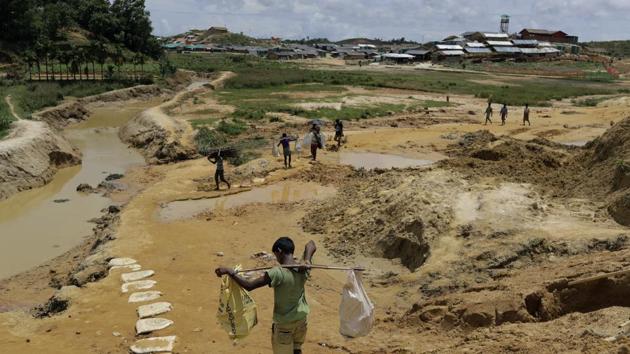 Ultimately, though, the topography of the camps is the biggest problem. The trees that once covered the hills have been cut down to make room for shelters, and the roots dug up for firewood. That process has dramatically loosened the soil, which the rains turn into heavy mud that slips down the hillsides, burying anything in its path. (Wong Maye-E / AP) Ultimately, though, the topography of the camps is the biggest problem. The trees that once covered the hills have been cut down to make room for shelters, and the roots dug up for firewood. That process has dramatically loosened the soil, which the rains turn into heavy mud that slips down the hillsides, burying anything in its path. (Wong Maye-E / AP)