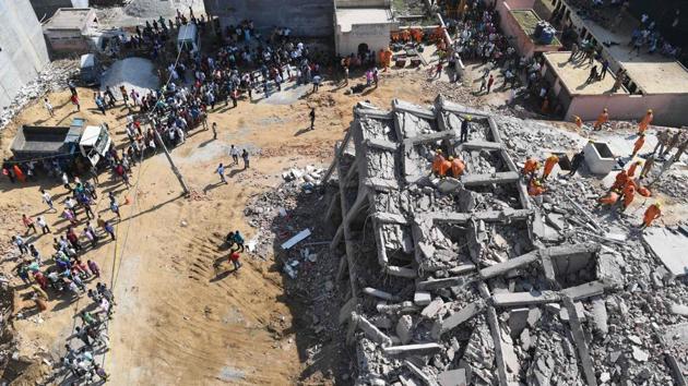 Fifteen hours after two buildings collapsed in Greater Noida’s Shahberi village, National Disaster Response Force personnel and local police teams continued to dig through the rubble in search of labourers and a family of four on Wednesday. Three bodies had already been recovered by early that morning. (Prakash Singh / AFP) Fifteen hours after two buildings collapsed in Greater Noida’s Shahberi village, National Disaster Response Force personnel and local police teams continued to dig through the rubble in search of labourers and a family of four on Wednesday. Three bodies had already been recovered by early that morning. (Prakash Singh / AFP)