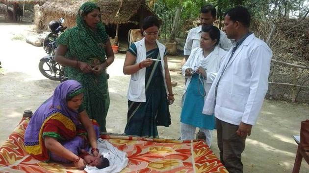 Baby care team checking baby and their mother at their home. The follow up becomes necessary to ensure the baby grows with correct weight.(HT Photo)