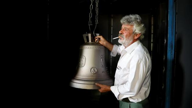 Thomas Galanopoulos, 59, holds a cleaned bell at his family's bell foundry. In one of Greece’s last remaining bell foundries in the small, western town of Paramythia, the Galanopoulos brothers are busy casting church bells heading to Ethiopia and Romania, pouring red-hot molten metal into moulds of varying sizes. (Alkis Konstantinidis / REUTERS)