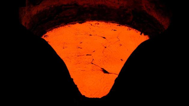 Melted metal alloy that will be cast in bell moulds at the Galanopoulos bell foundry. This family-run business has been around for 215 years. These days, exports keep it alive. “More than half of our production goes abroad,” said Thomas Galanopoulos, 59, the elder of the two, wreathed in smoke rising from melting copper and tin. (Alkis Konstantinidis / REUTERS)