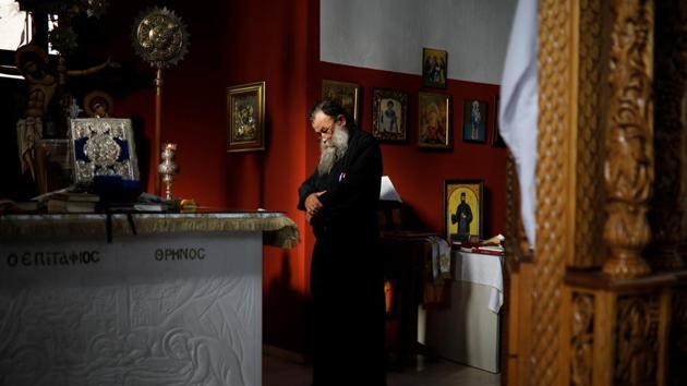 Father Theodoros Zois, who bought six bells from the Galanopoulos, prays inside his church in Igoumenitsa, Greece. The Greek Orthodox Church permeates life in Greece. But when the economic crisis hit, domestic demand collapsed. The Church, not spared by the crisis, cut expenses to meet the costs of its soup kitchens and charities. Building or restoration work on churches often ceased. (Alkis Konstantinidis / REUTERS)