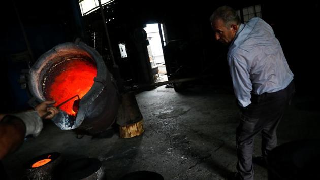 Christos Galanopoulos, 55, casts melted metal in a bell mould at the Galanopoulos bell foundry. Still, the buzz of the foundry rarely stops. The craft, a painstaking process of mostly manual labour, has remained largely unchanged since the 12th century. (Alkis Konstantinidis / REUTERS)