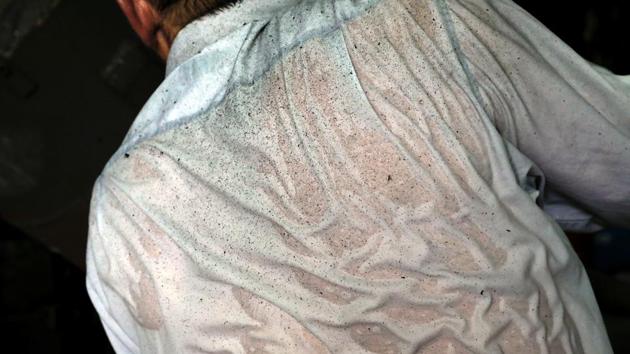 Sweat and sand are seen on Christos Galanopoulos' shirt as he casts melted metal in a bell mould. Christos also applies figures and inscriptions by hand, stenciling backwards. When they’re not casting bells, they’re tuning cowbells on a grindstone. “I spend more time here than at home. Even Sundays,” he smiled. (Alkis Konstantinidis / REUTERS)