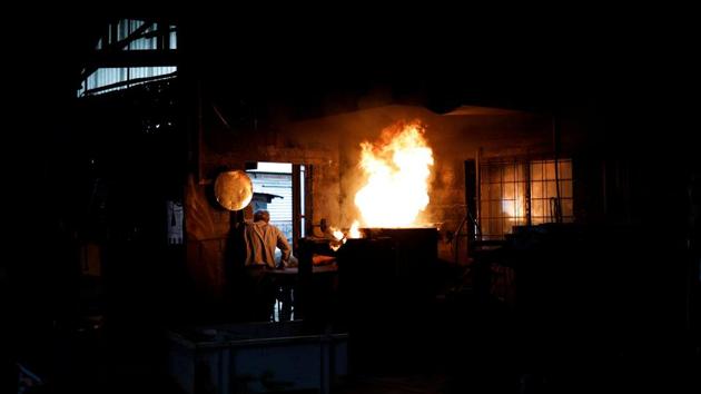 Flames rise from a furnace where metal alloy that will be cast in bell moulds is prepared, at the Galanopoulos bell foundry in Paramythia, Greece. The silence blanketing the Greek plain is broken by the tinkle of a cowbell and the rumble of the foundry’s blazing furnace. (Alkis Konstantinidis / REUTERS)