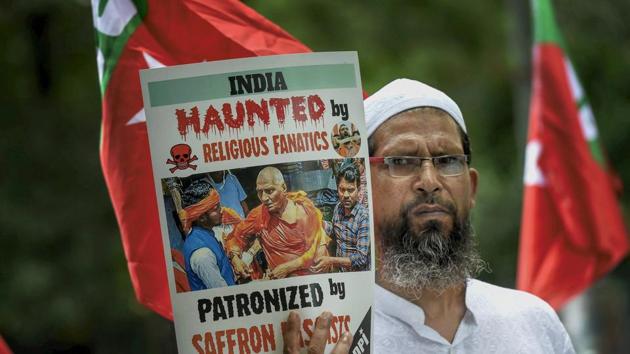 A member of Social Democratic Party of India displays a placard during a protest over an assault on social activist Swami Agnivesh allegedly by members of Bharatiya Janta Yuva Morcha (BJYM), in New Delhi. (Kamal Singh / PTI) A member of Social Democratic Party of India displays a placard during a protest over an assault on social activist Swami Agnivesh allegedly by members of Bharatiya Janta Yuva Morcha (BJYM), in New Delhi. (Kamal Singh / PTI)