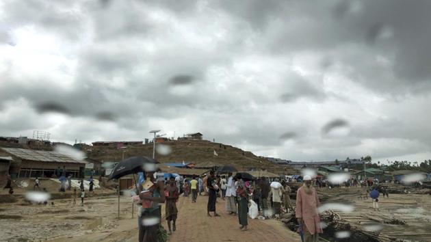 Rohingya refugees walk in the rain though Jamtoli refugee camp in Bangladesh. The monsoon season has arrived in Bangladesh, bringing fresh dangers to the 900,000 Rohingya refugees who live in ramshackle huts on unstable hills. The threat of landslides is so dire that some have already evacuated. (Wong Maye-E / AP) Rohingya refugees walk in the rain though Jamtoli refugee camp in Bangladesh. The monsoon season has arrived in Bangladesh, bringing fresh dangers to the 900,000 Rohingya refugees who live in ramshackle huts on unstable hills. The threat of landslides is so dire that some have already evacuated. (Wong Maye-E / AP)