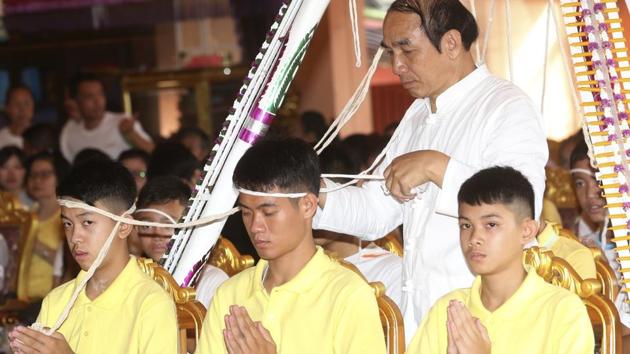 Soccer coach Ekkapol Janthawon (centre) and members of the rescued soccer team attend a Buddhist ceremony in Mae Sai district, Chiang Rai province, northern Thailand, Thursday, July 19, 2018. (AP) Soccer coach Ekkapol Janthawon (centre) and members of the rescued soccer team attend a Buddhist ceremony in Mae Sai district, Chiang Rai province, northern Thailand, Thursday, July 19, 2018. (AP)