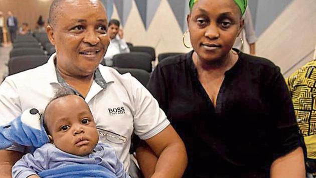 Four-month-old organ recipient Ryan Lyimo with his parents Elirabi (left, donor) and Loveness.(Bachchan Kumar)