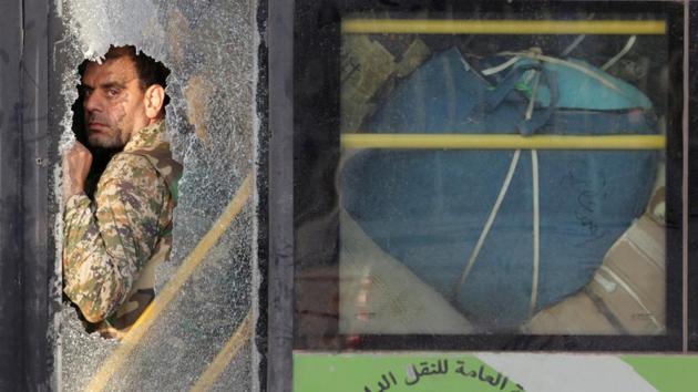 A fighter loyal to Syrian President Bashar al Assad is seen during the evacuation from the villages of al-Foua and Kefraya, Syria. (Khalil Ashawi / REUTERS) A fighter loyal to Syrian President Bashar al Assad is seen during the evacuation from the villages of al-Foua and Kefraya, Syria. (Khalil Ashawi / REUTERS)