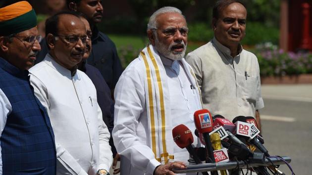 Narendra Modi stands with senior BJP leaders as he addresses media after arriving for the monsoon session of Parliament in New Delhi on Wednesday. (AFP Photo) Narendra Modi stands with senior BJP leaders as he addresses media after arriving for the monsoon session of Parliament in New Delhi on Wednesday. (AFP Photo)