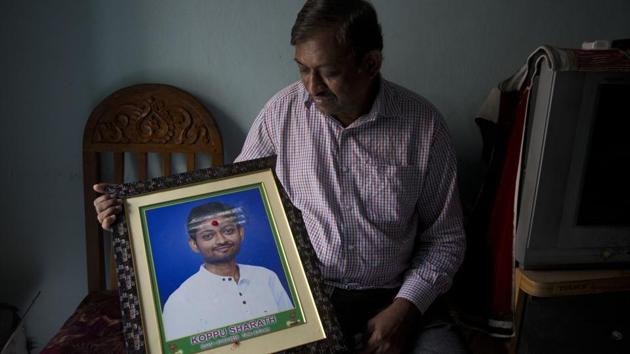 Koppu Ram Mohan, father of Indian student Sharath Koppu who was shot dead in the US holds a photograph of his son in Hyderabad on July 17, 2018. The 25-year-old was shot on July 6 during an armed robbery at a fast food restaurant in Kansas City where he worked. (Mahesh Kumar A / AP)