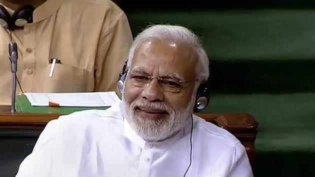 Prime Minister Narendra Modi reacts to Congress President Rahul Gandhi's speech during a debate on no-confidence motion in Lok Sabha during the Monsoon session of Parliament.(PTI Photo)