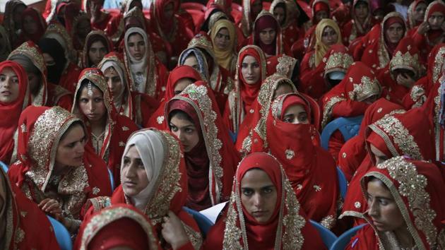 Kashmiri Shiite Muslim brides sit for a mass marriage event in Srinagar on July 15, 2018. Mass weddings in India are organized by social organizations primarily to help the economically backward families who cannot afford the ceremony costs as well as the customary dowry and expensive gifts that are still prevalent in many communities. (Mukhtar Khan / AP)