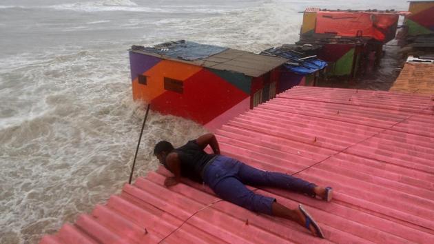 A man inspects his house during high tide at the sea front in Mumbai, India, July 15, 2018. (Francis Mascarenhas / REUTERS)