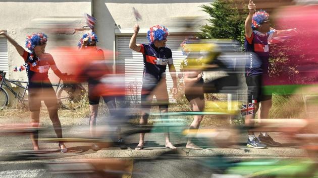 British fans wave Union Jack flags during the first stage of the race on July 7, 2018. (Marco Bertorello / AFP) British fans wave Union Jack flags during the first stage of the race on July 7, 2018. (Marco Bertorello / AFP)