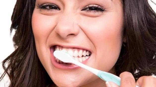 For good dental hygiene, ensure that you don’t brush too hard as it can wear down the teeth enamel and damage gums.(Shutterstock)