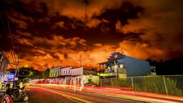 The night sky is illuminated by a lava eruption in Pahoa, Hawaii. Stunning images of Kilauea volcano erupting have captivated people around the world. But it’s nearly impossible for residents and visitors on the ground to see the lava -- a fact that’s squeezing the tourism dependent local economy. Businesses are calling for a lava viewing site, but authorities say it’s difficult to set one up safely. (Dennis Oda / AP) The night sky is illuminated by a lava eruption in Pahoa, Hawaii. Stunning images of Kilauea volcano erupting have captivated people around the world. But it’s nearly impossible for residents and visitors on the ground to see the lava -- a fact that’s squeezing the tourism dependent local economy. Businesses are calling for a lava viewing site, but authorities say it’s difficult to set one up safely. (Dennis Oda / AP)