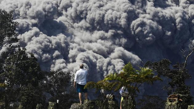 Jack Jones, visiting from Madison, Wisconsin, takes pictures at a country club in Volcano, Hawaii as a huge ash plume rises from the summit of Kiluaea. The volcano has been erupting continuously for 35 years, attracting travellers. But now, Kilauea is behaving differently, erupting as much as 3,500 cubic feet per second compared with about 141 cubic feet two years ago. (Jae C. Hong / AP) Jack Jones, visiting from Madison, Wisconsin, takes pictures at a country club in Volcano, Hawaii as a huge ash plume rises from the summit of Kiluaea. The volcano has been erupting continuously for 35 years, attracting travellers. But now, Kilauea is behaving differently, erupting as much as 3,500 cubic feet per second compared with about 141 cubic feet two years ago. (Jae C. Hong / AP)