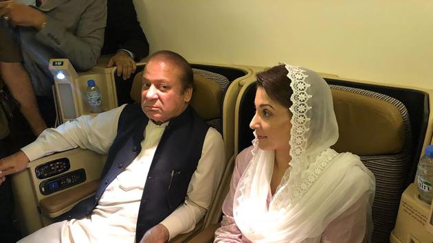 This handout photograph released by Pakistan Muslim League Nawaz (PML-N) party on July 14, 2018, show former prime minister Nawaz Sharif (L) and his daughter Maryam Nawaz siting on a plane after their arrival in Lahore.(AFP)