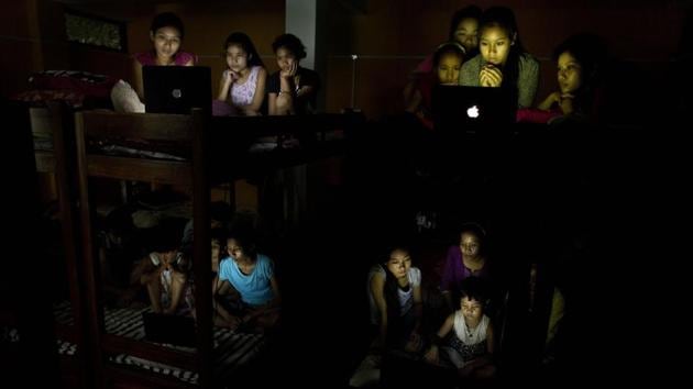 Children at a school hostel watch the World Cup soccer final match between France and Croatia on laptops, on the outskirts of Guwahati, Assam on July 15, 2018. (Anupam Nath / AP)