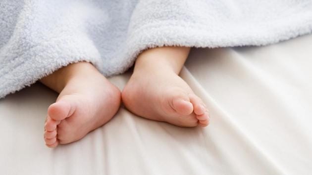 Baby's feet sticking out from blanket.(Getty Images/Blend Images)