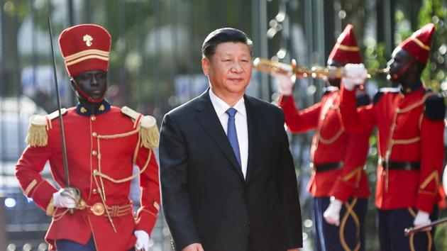 Chinese President Xi Jinping walks along the red carpet in front of a Guard of Honour at the Presidential Palace during his visit to Dakar, Senegal.(REUTERS)
